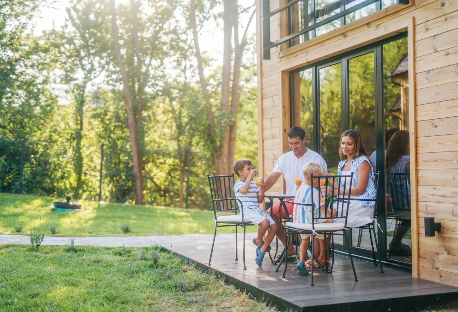 Family enjoying drinks on a cabin deck
